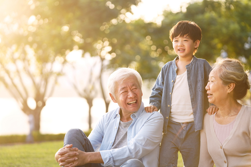 asian grandparent and grandson having fun outdoors in park
